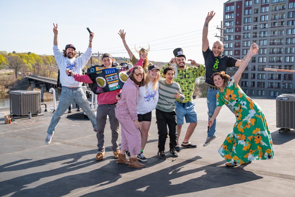 group of people on a rooftop jumping for joy 
