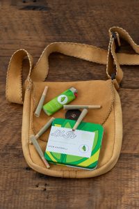 couple of joints on top of a brown purse